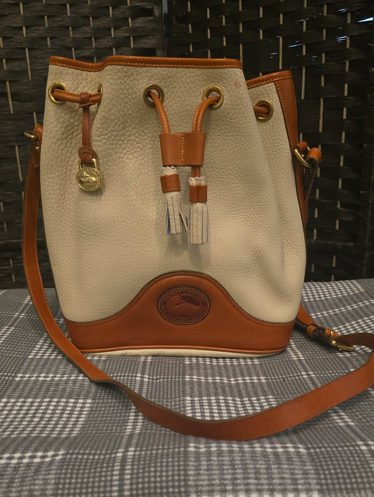 Dooney & Bourke Cream And Brown Pebbled Leather Medium Drawstring Bucket Bag